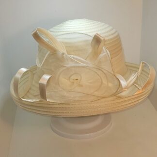 Cream wide brim hat with flower and satin ribbons. Front view.