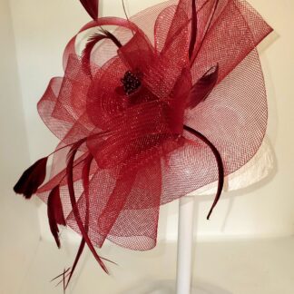Burgundy clip on hat, left side view with stand.