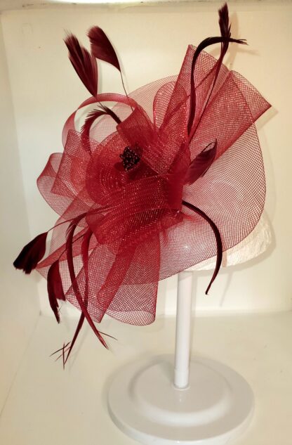 Burgundy clip on hat, left side view with stand.