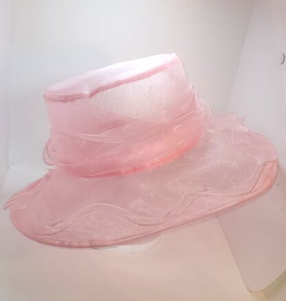 Pink wide brim hat with bow, left side view.